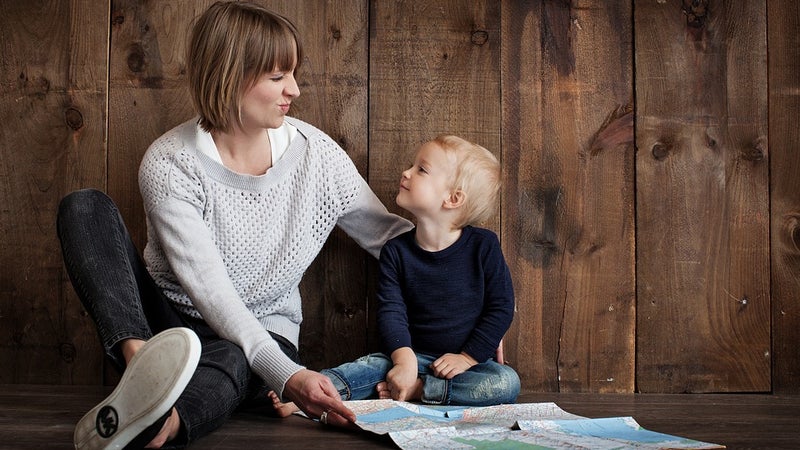 A mother and child sitting on the floor