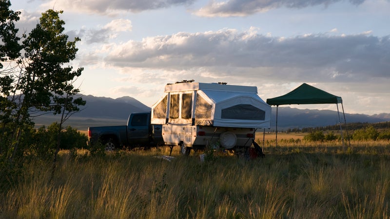A pop-up camper in a field