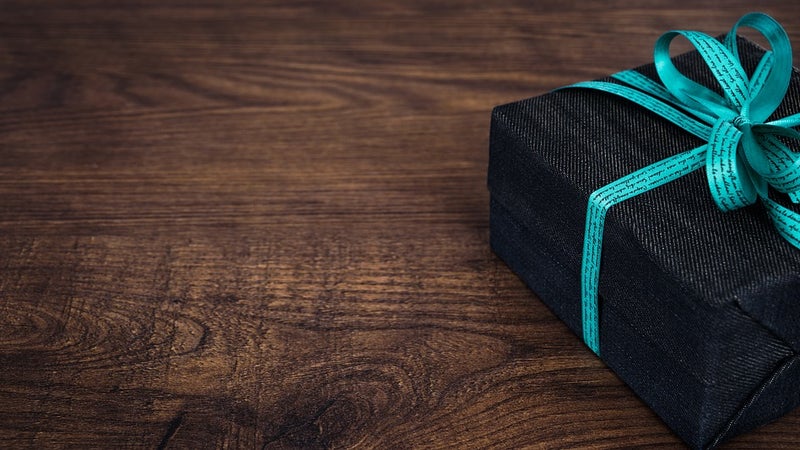 A wrapped gift on hardwood floor