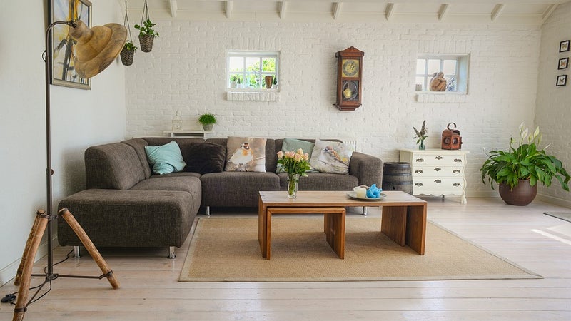 A living room with a couch, table, and decorative pieces
