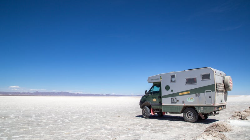 A truck and mounted camper in the desert