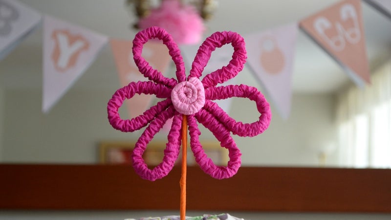 A baby shower decoration in the shape of a flower