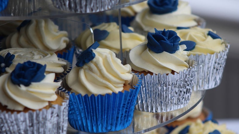 Cupcakes with white frosting on a display