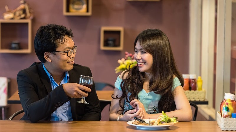 A man and woman sitting together in a restaurant or bar